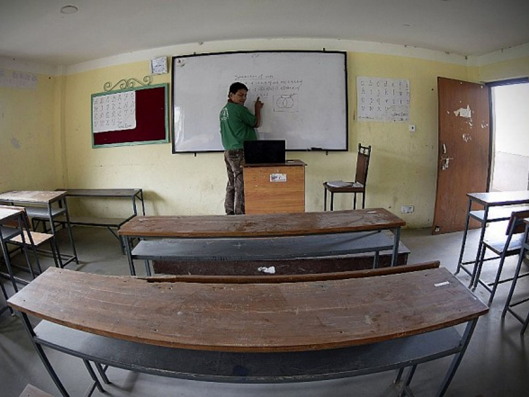 A teacher giving an online class in an empty school in Lalitpur, Nepal