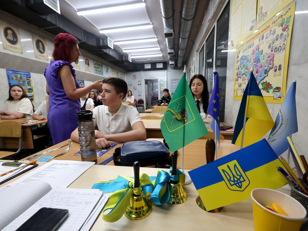 A teacher speaks to students during the Last Bell celebration, which marks the end of the school year in Kharkiv, northeastern Ukraine.