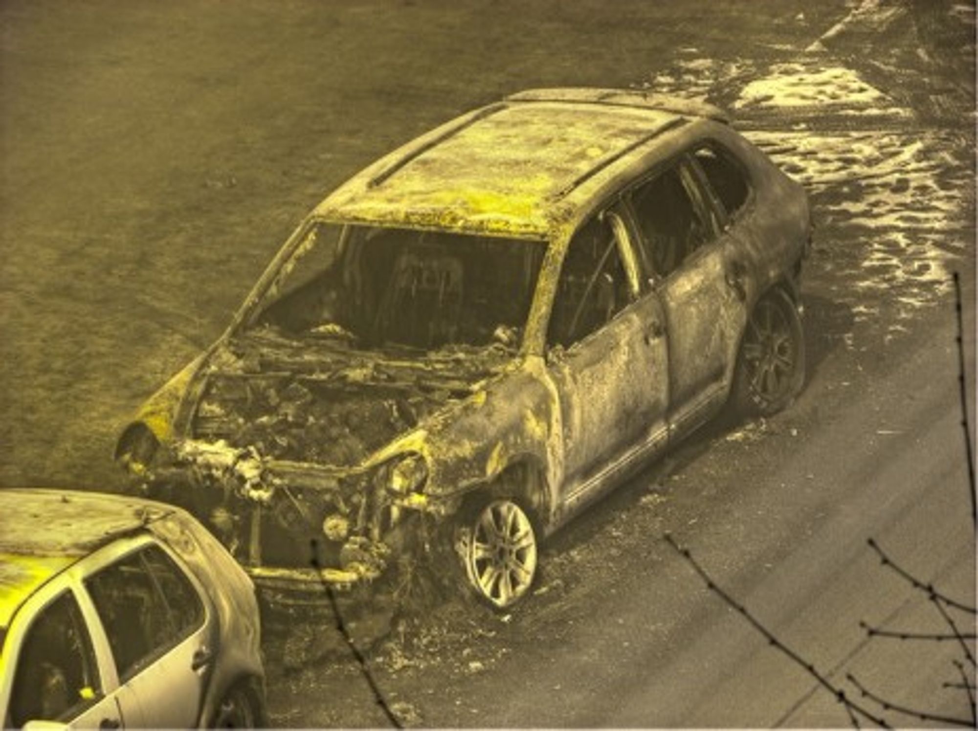 A torched luxury car in Berlin, Germany (2009)