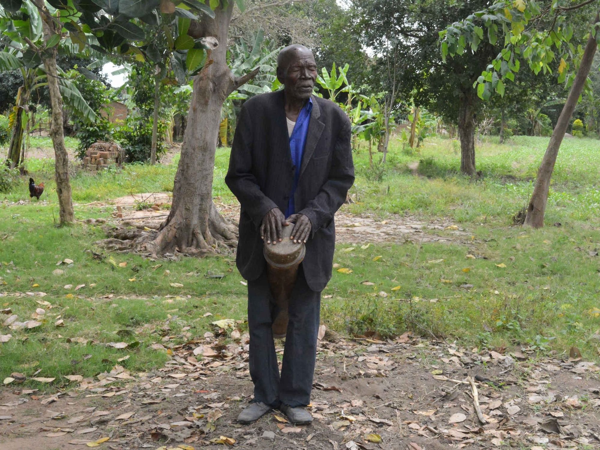 A Ugandan musician playing the fumbo during the ajore dance, a traditional burial rite