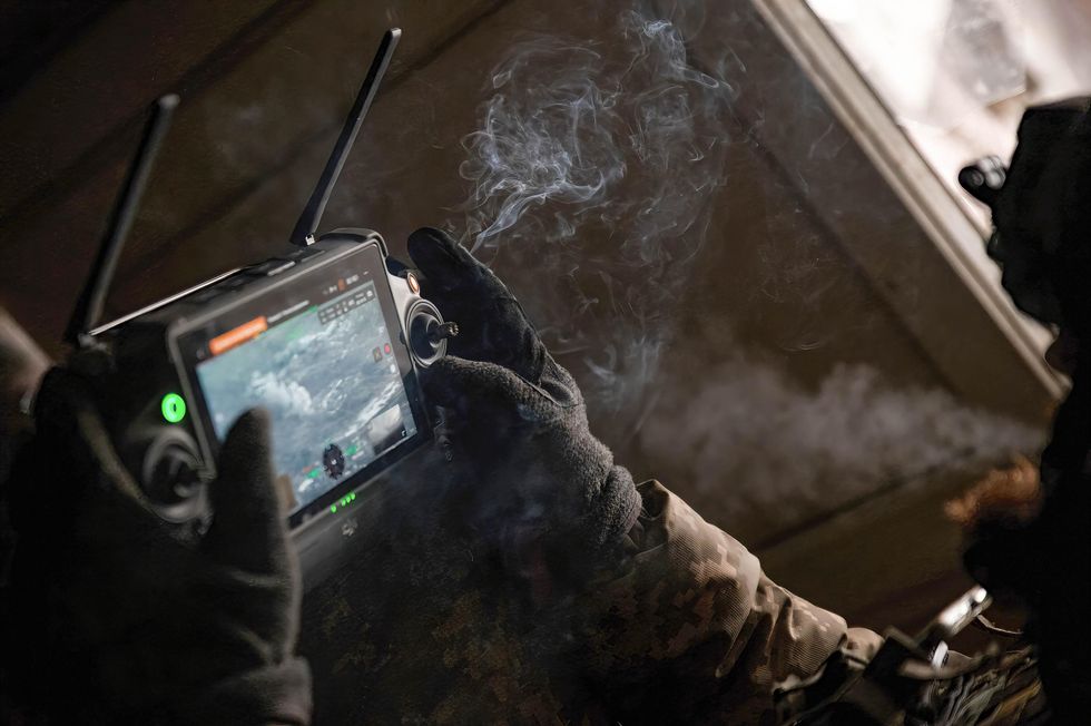 A Ukrainian drone operator watches as artillery strikes Russian positions