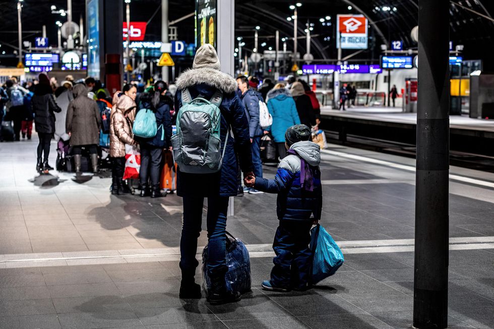 A Ukrainian mother and son stand on the platform at the Berlin Central Station