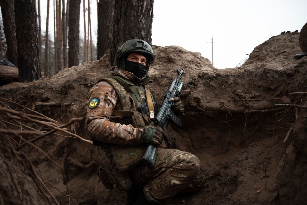 A Ukrainian soldier in a trench carries a AK-74 near Slovyansk to stop the advance of Russian armed forces