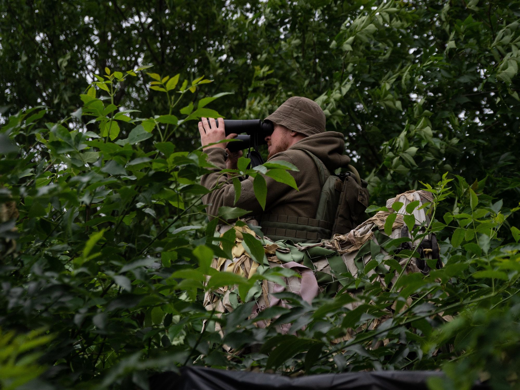 A Ukrainian soldier observes his enemies in the Kharkiv region.