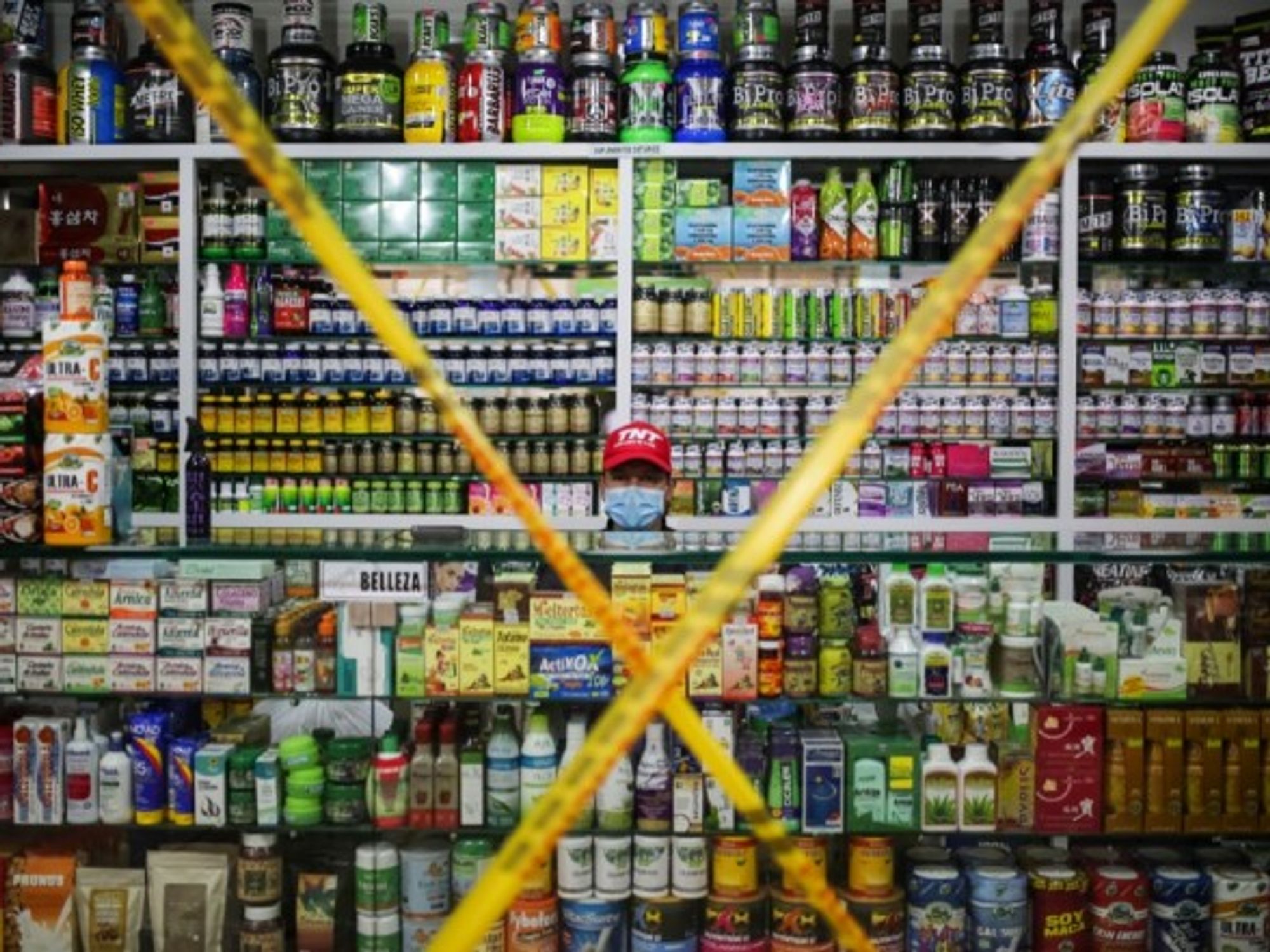 A vendor sits in a store awaiting customers in Bogota, Colombia.