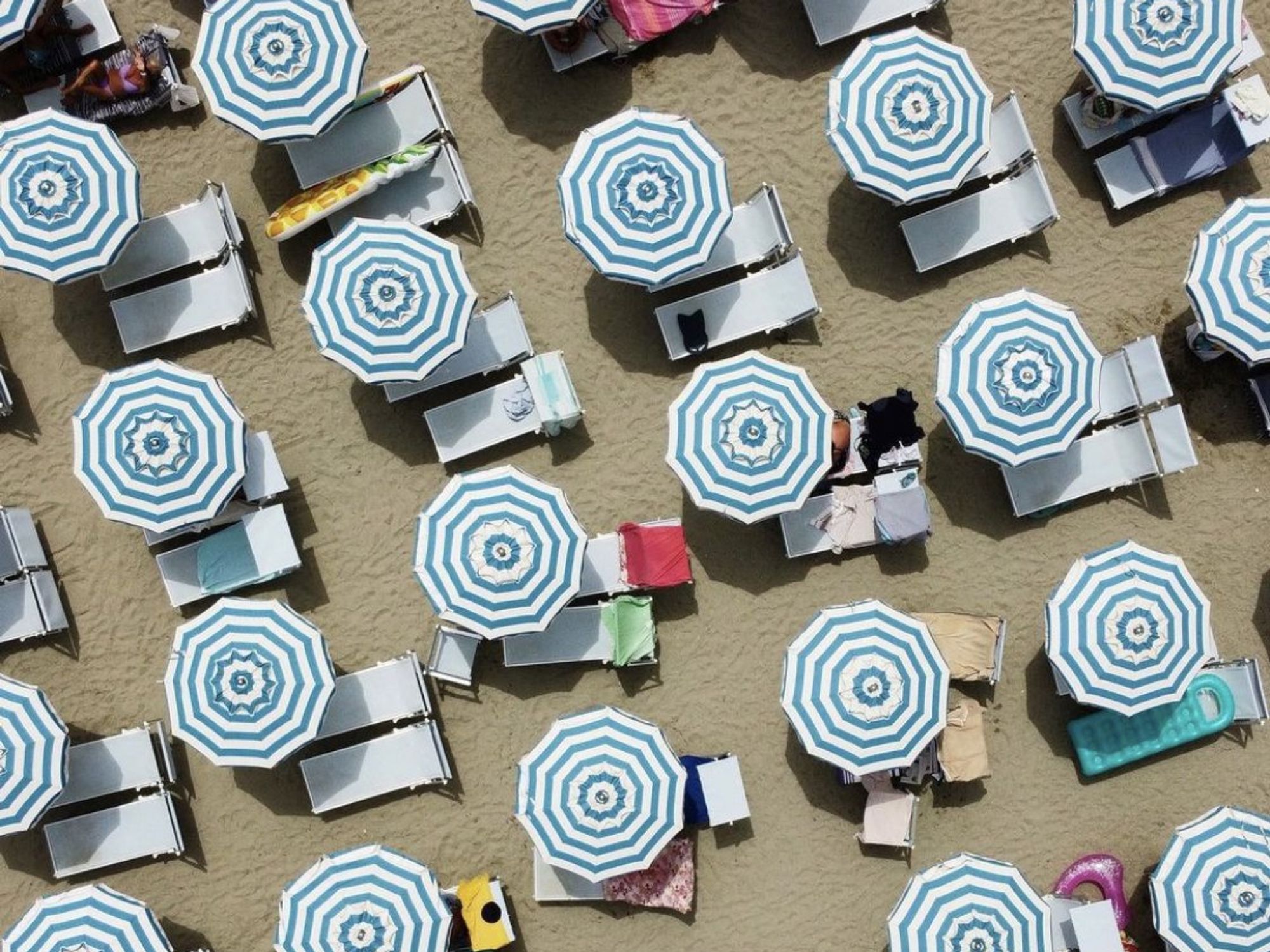 A view of stripped parasols from above of at Paraggi beach.