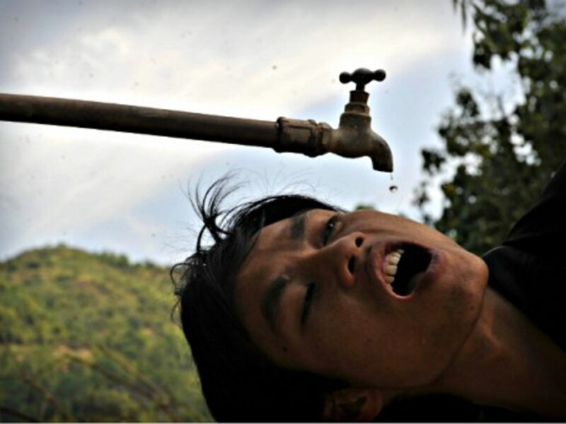 A villager drinks drips of water in Zhongbang Village, southern China