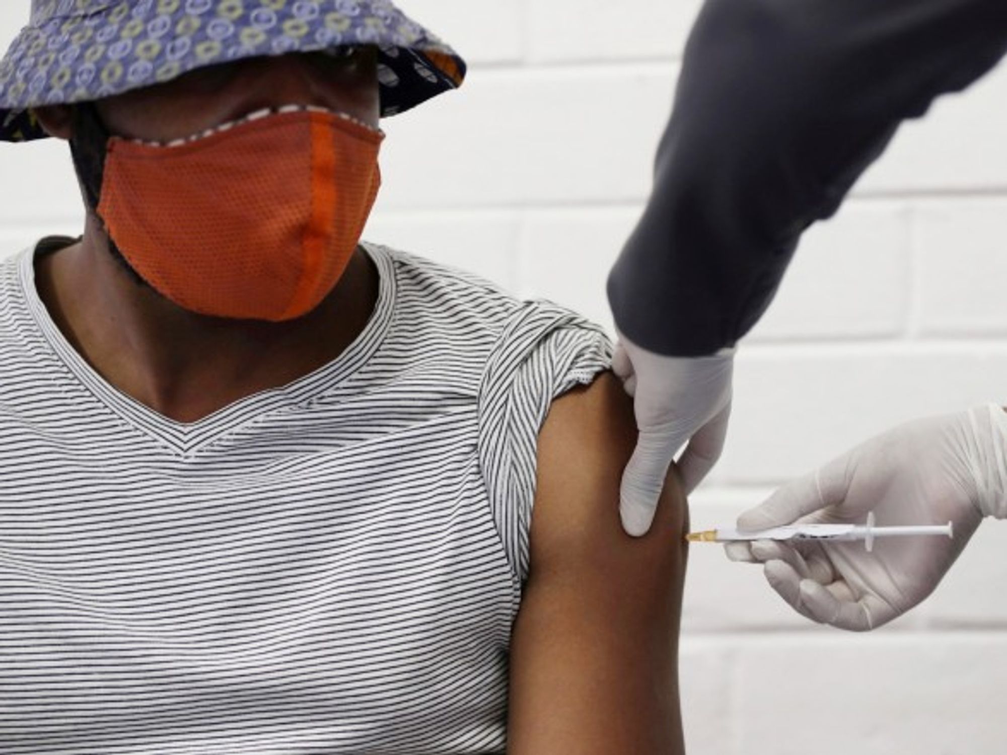 A volunteer receives a COVID-19 test vaccine injection