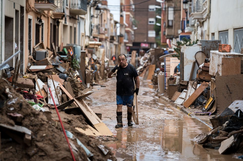 A volunteer walks in the street, in Paiporta, the worst-affected town of the Valencian Community.