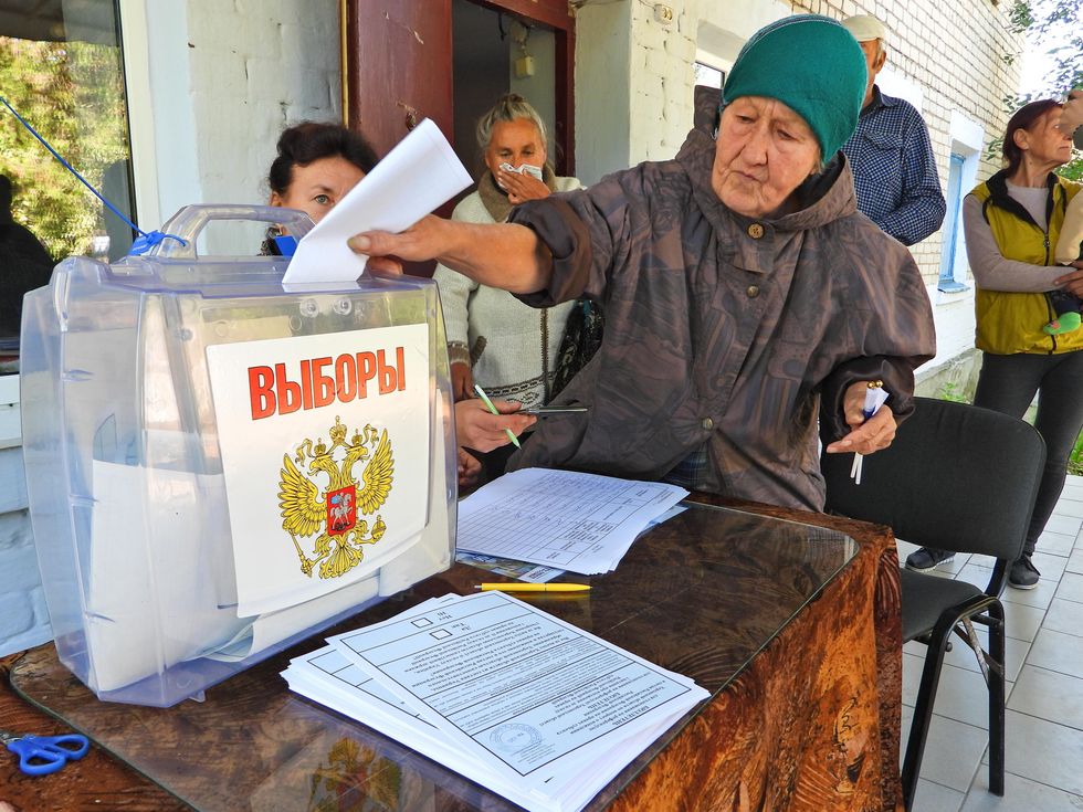 A voter casts a ballot in the village of Oleksandrivka during a referendum on joining Russia in the Kherson Region