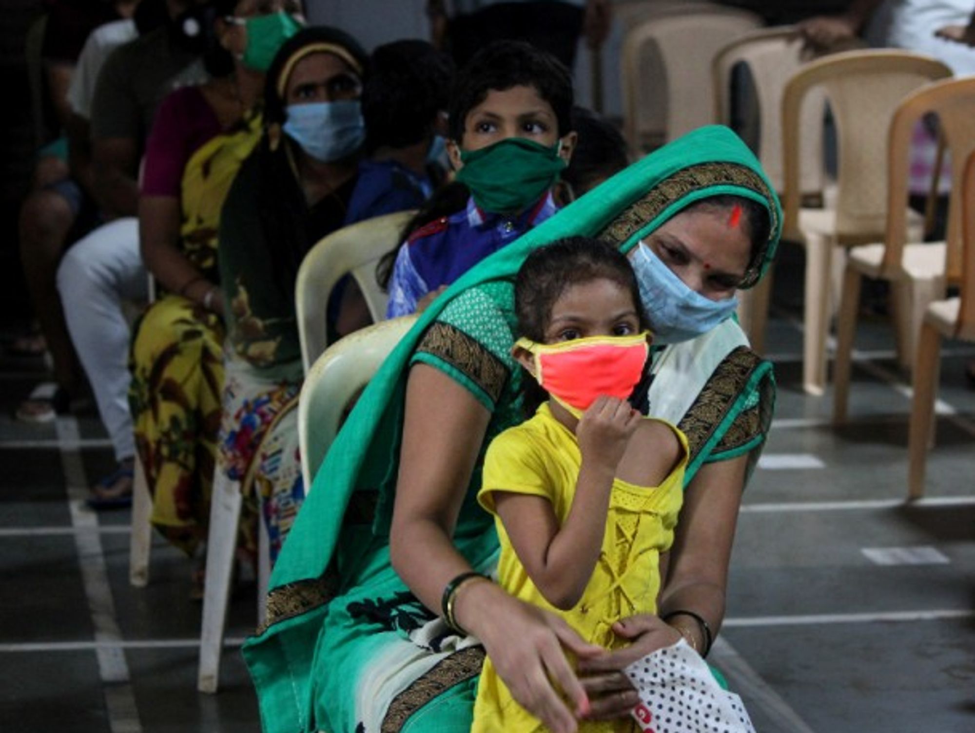 A woman and her daughter wait to get tested for the coronavirus.
