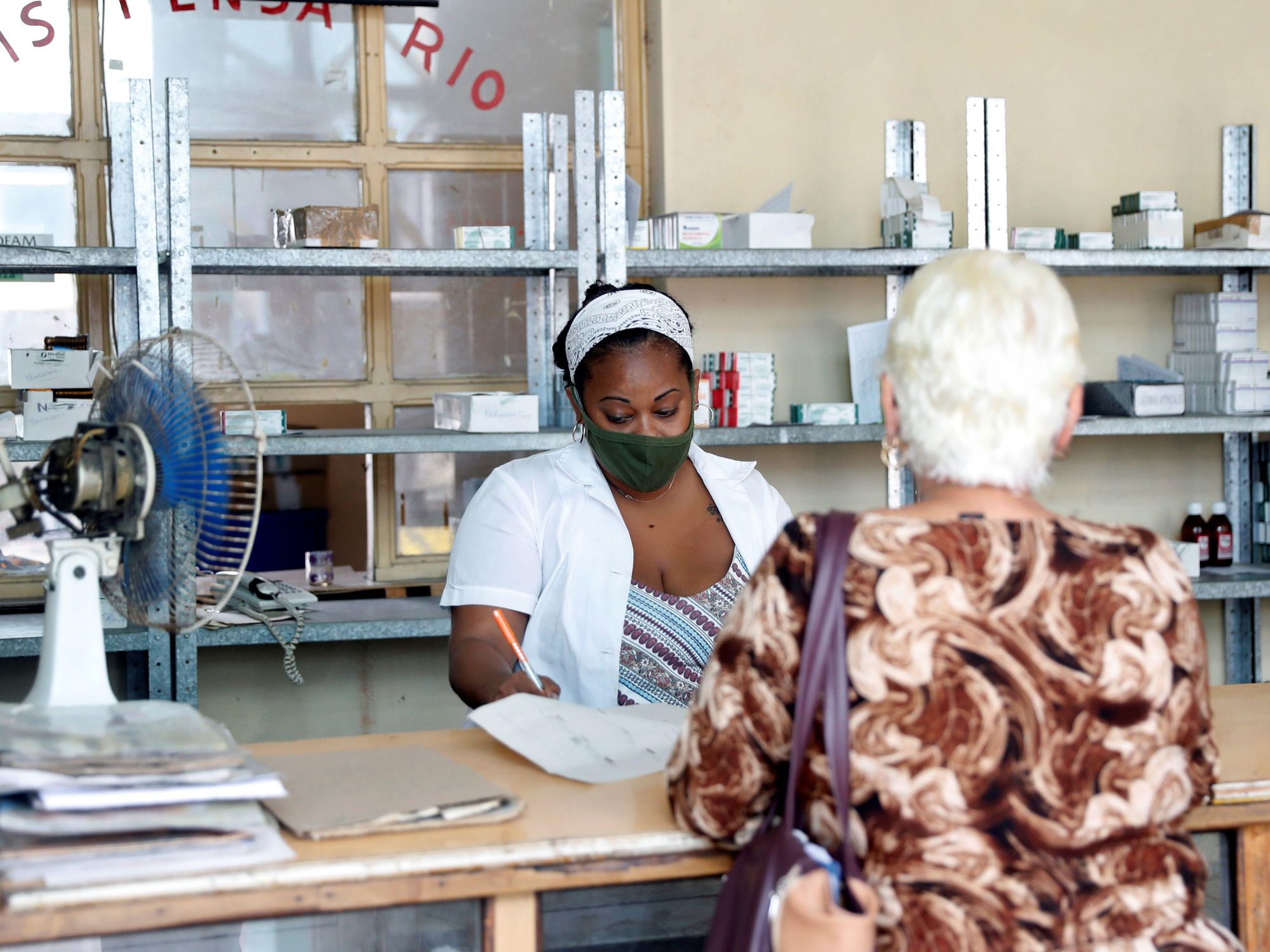 A woman buys medicine in a pharmacy with almost no products amid COVID19 pandemic , in Cuba