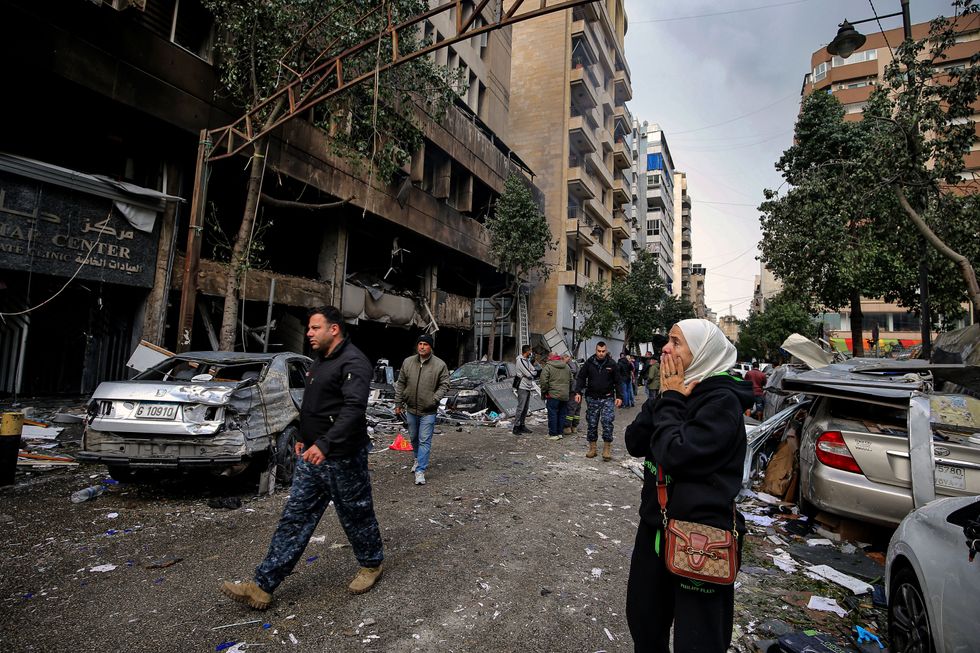 A woman covers her face in horror in reaction to the destruction caused by an Israeli air strike in Beirut, Lebanon that killed two people and wounded 22 others.