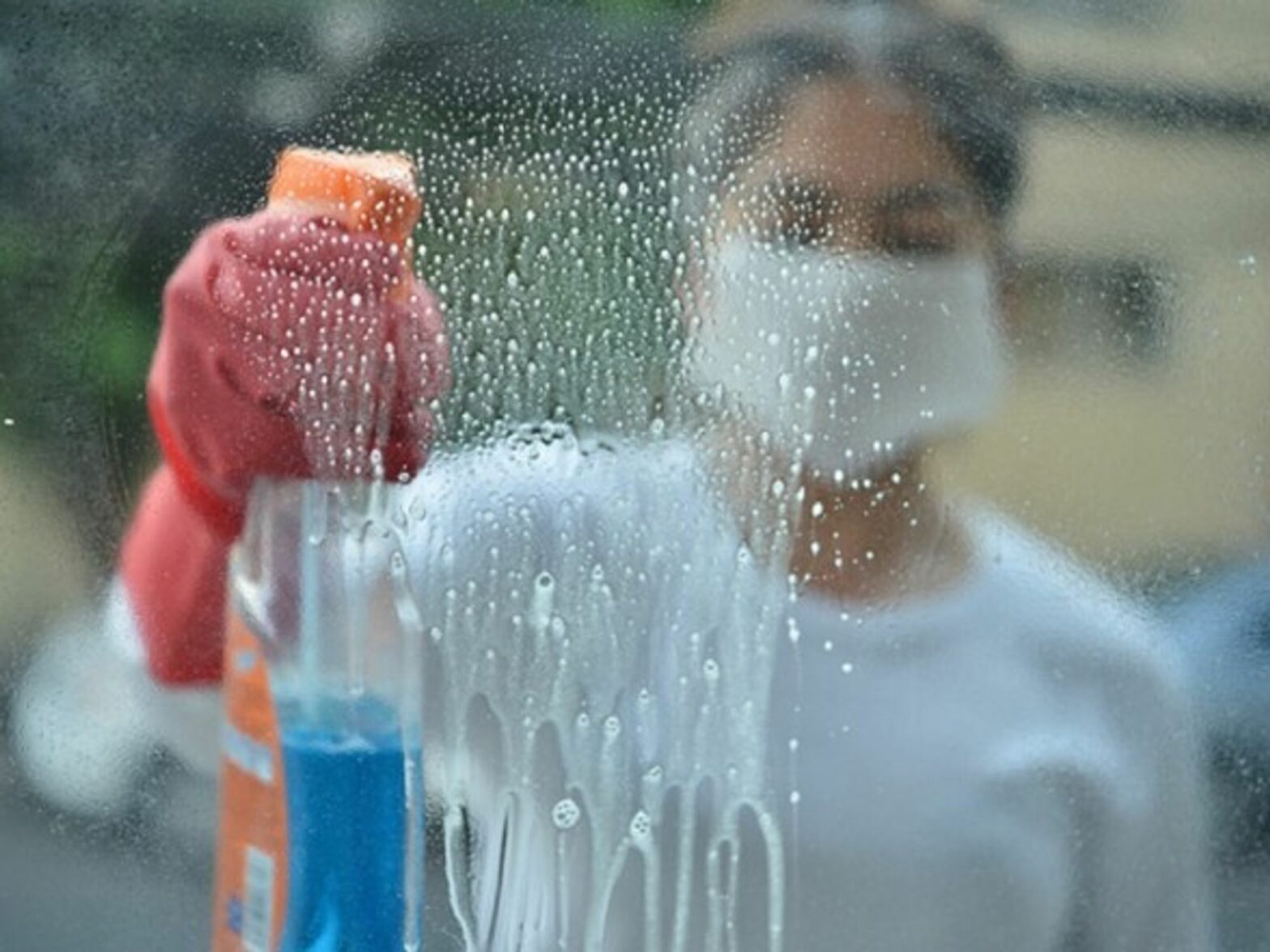 A woman disinfects surfaces with cleaning products in Mexico City
