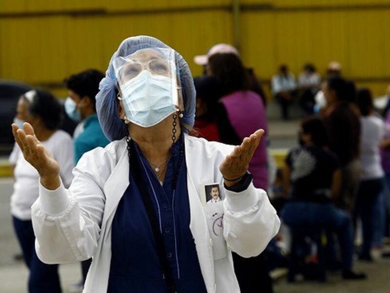 A woman doctor praying.