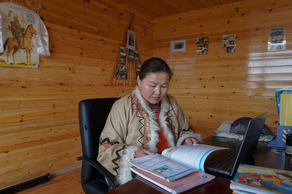 A woman holding a manual.