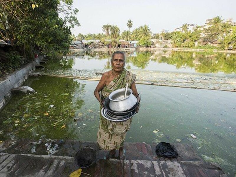 A woman holding crockery.