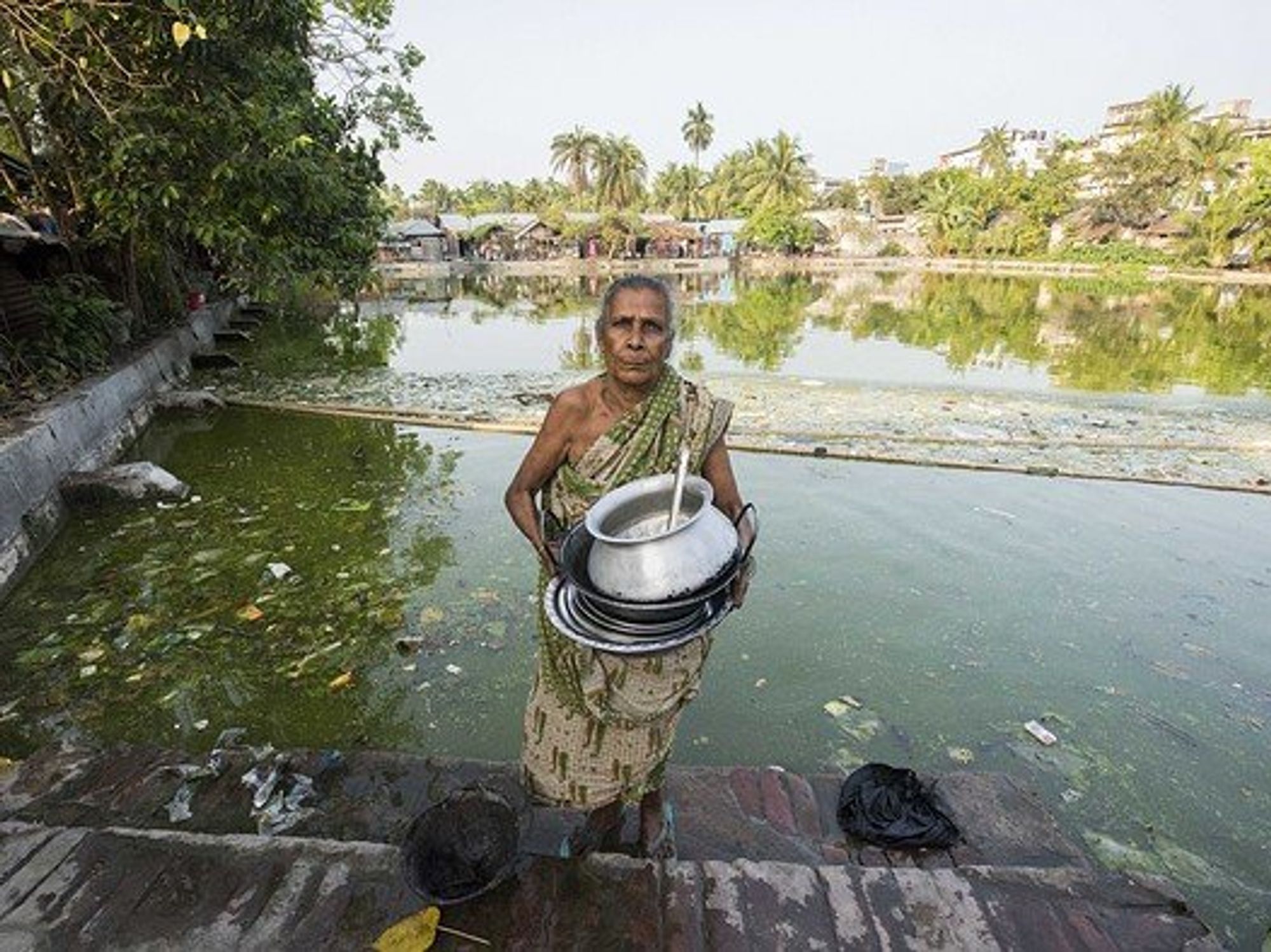 A woman holding crockery.