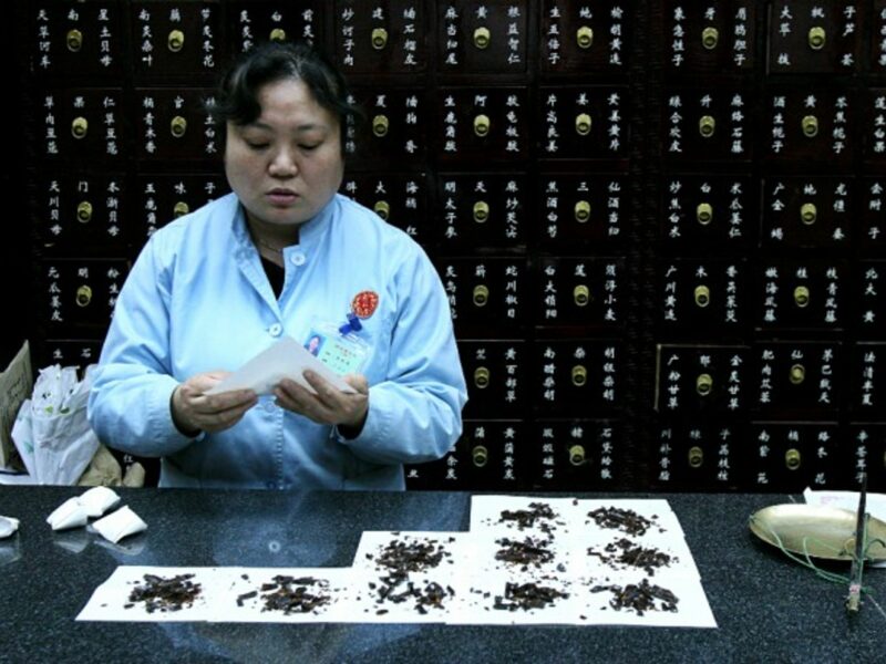 A woman in Beijing packaging medicine