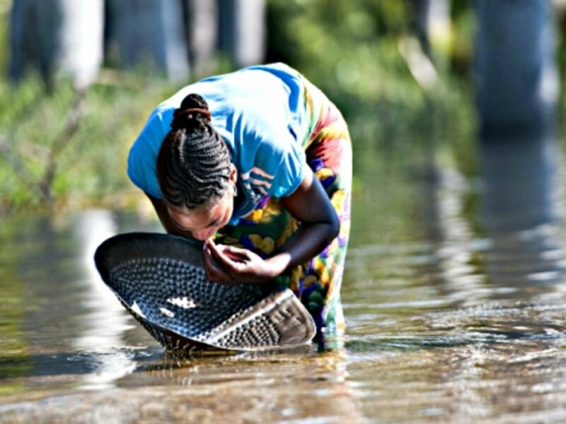 A woman looks for sapphire in a river in Ilakaka in southwest Madagascar