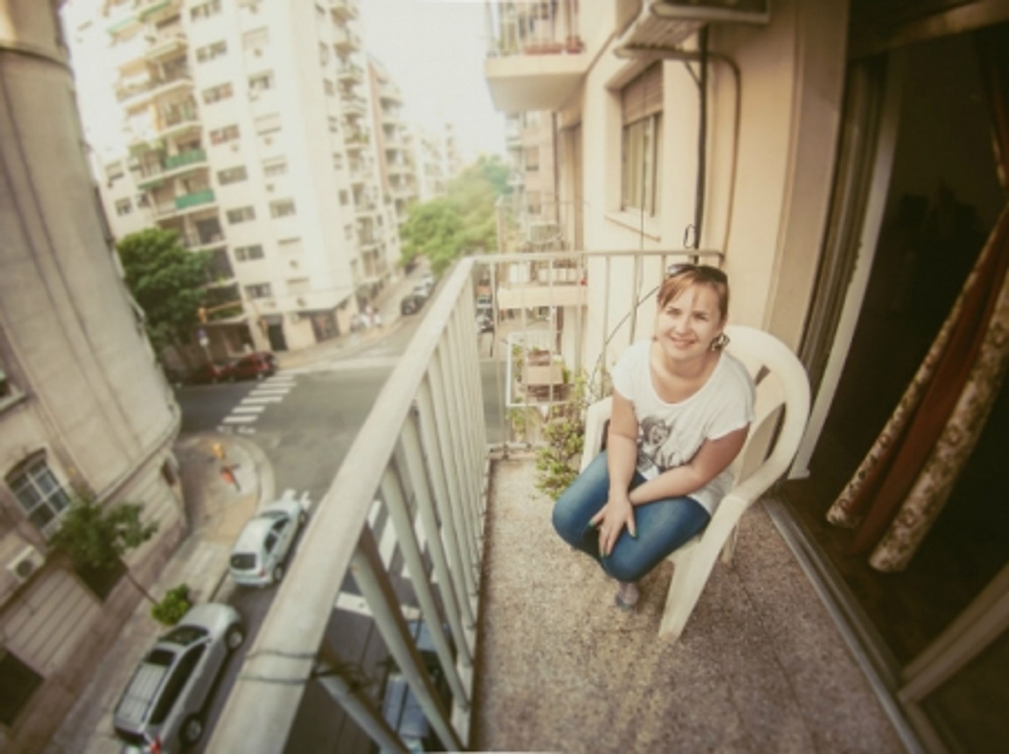 A woman on her tiny balcony in Buenos Aires