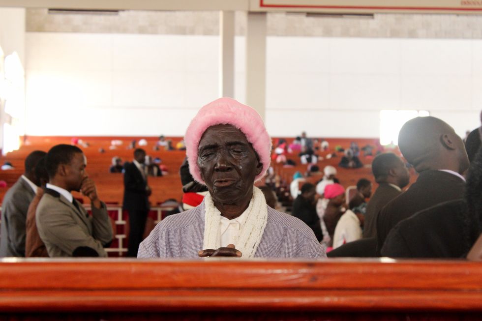 A woman praying in a church.
