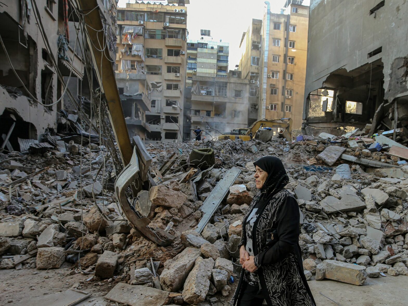 A woman reacts as she walks in front of flattened buildings that were targeted by Israeli air raids in central Beirut. At least 22 people were killed and 117 others were wounded,