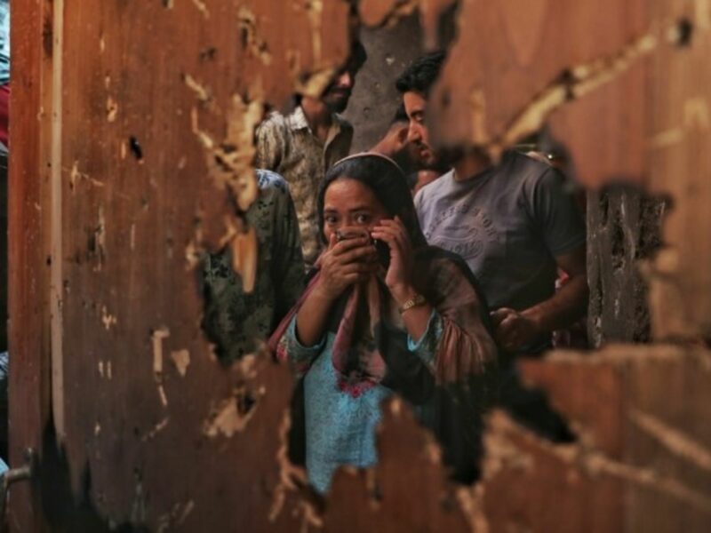 A woman reacts to the damage left from a gunfight between militants and police in the Kashmiri city of Srinagar