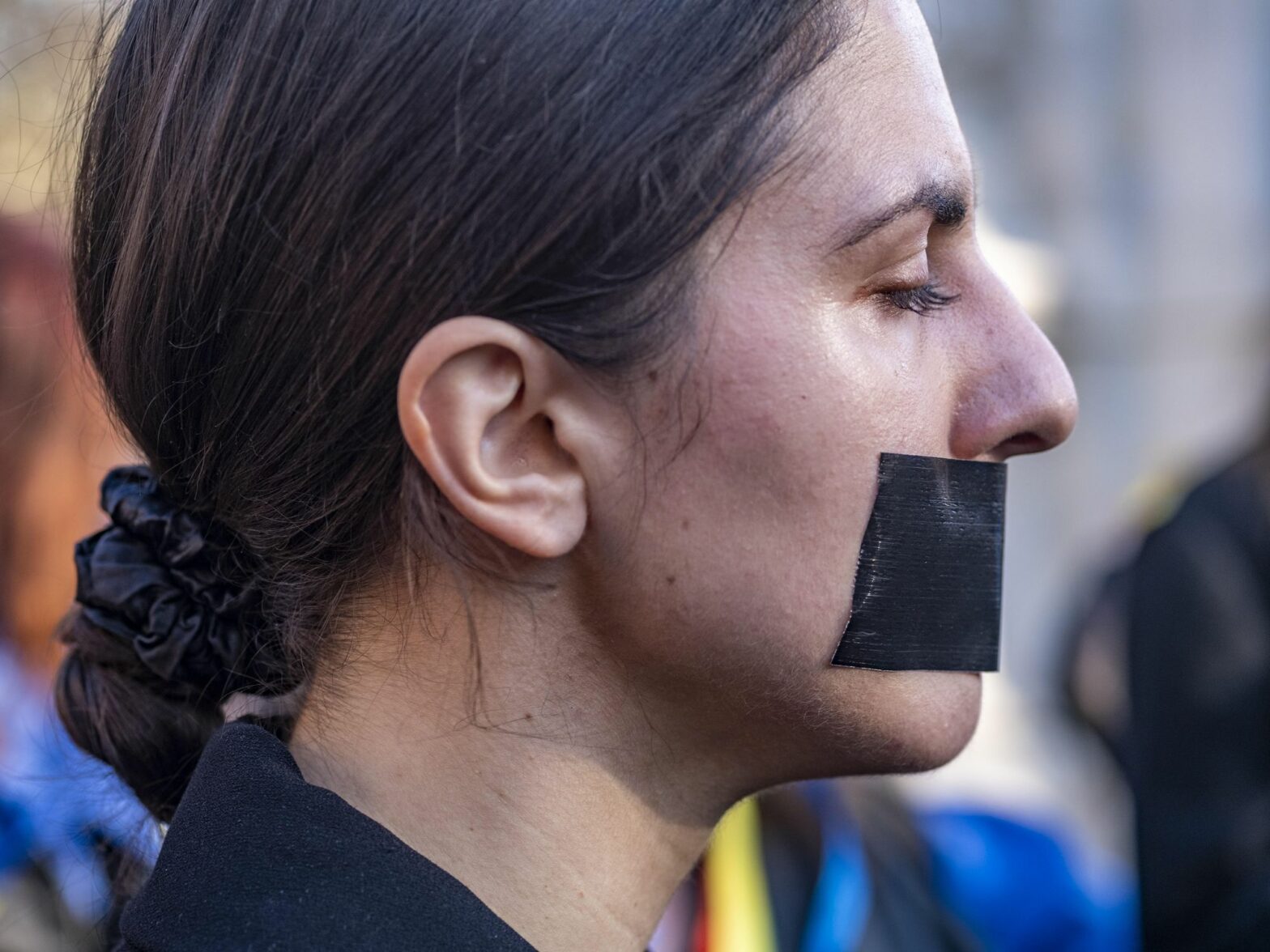 A woman taped her mouth to protest Russian rapes in Ukraine.