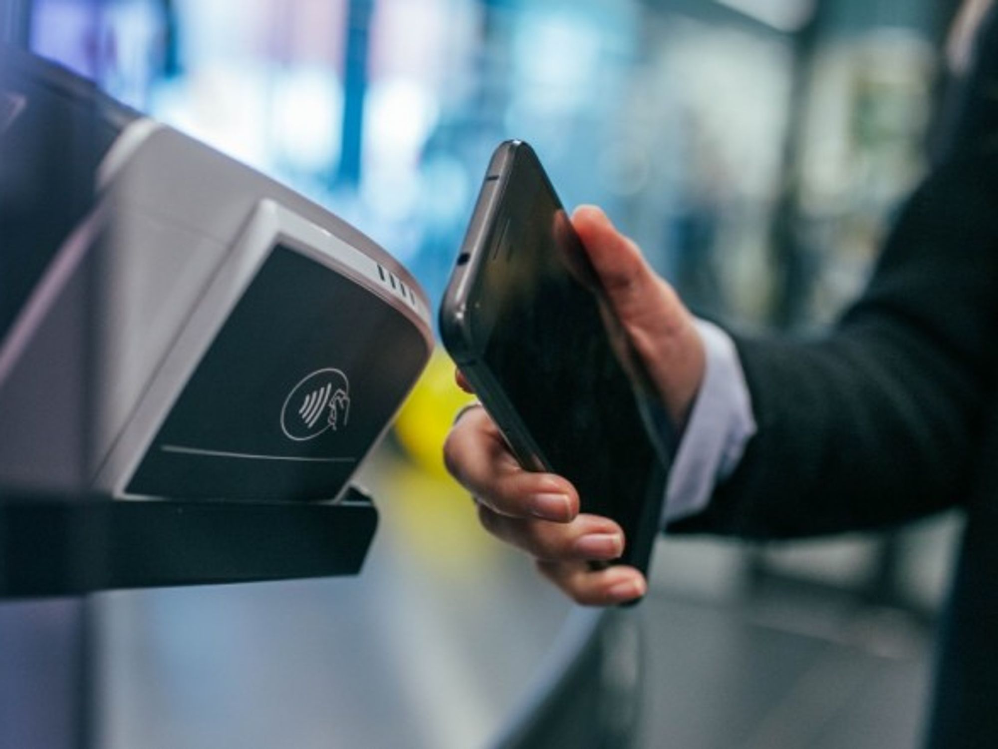 A woman using mobile payment in Ghent, Belgium.