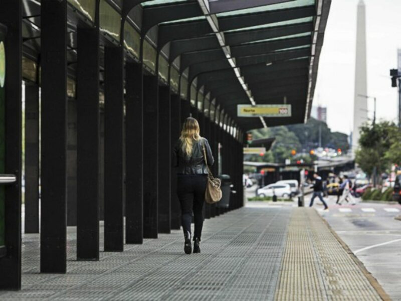 A woman walking through a bus station in Buenos Aires