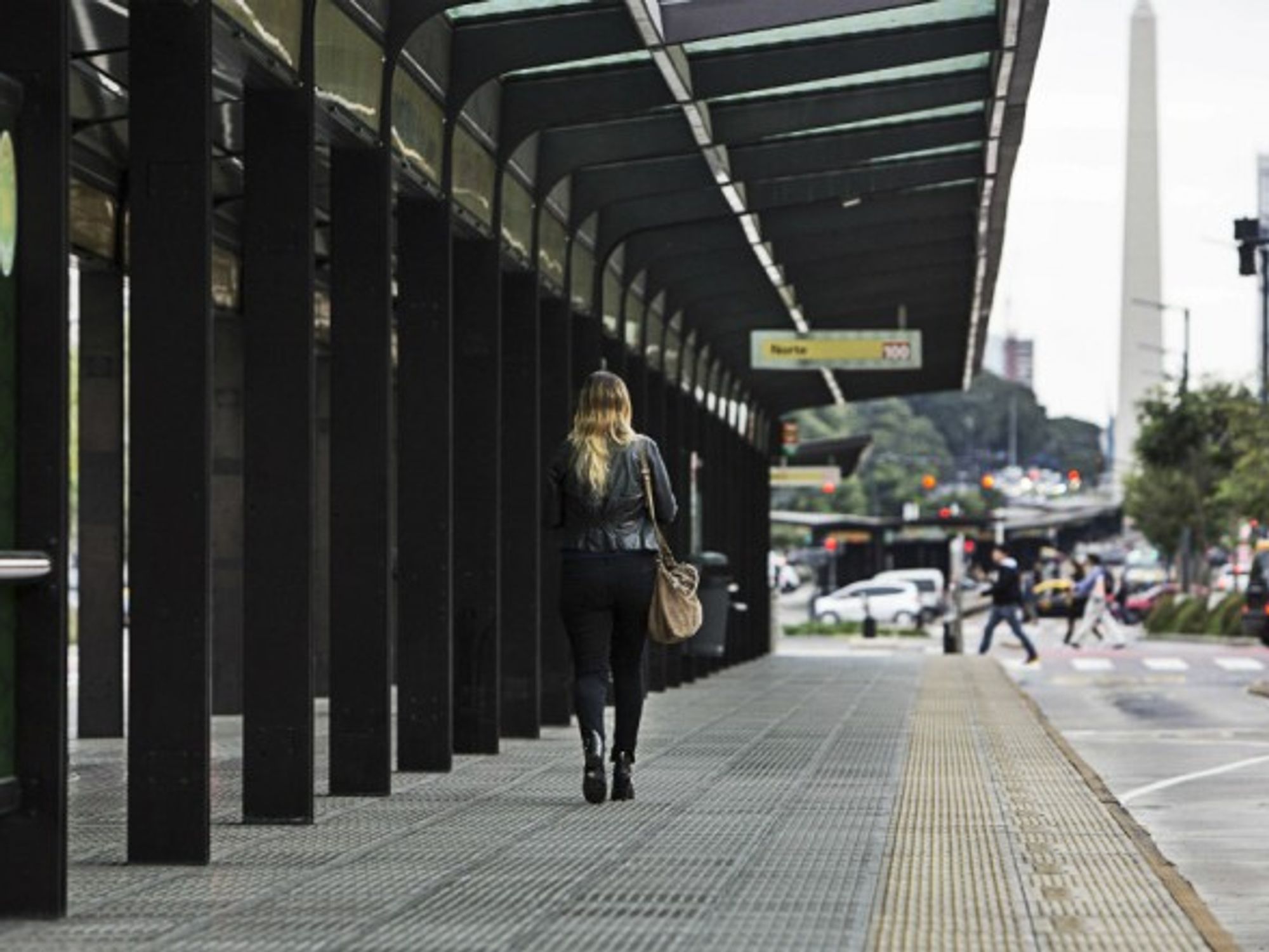 A woman walking through a bus station in Buenos Aires