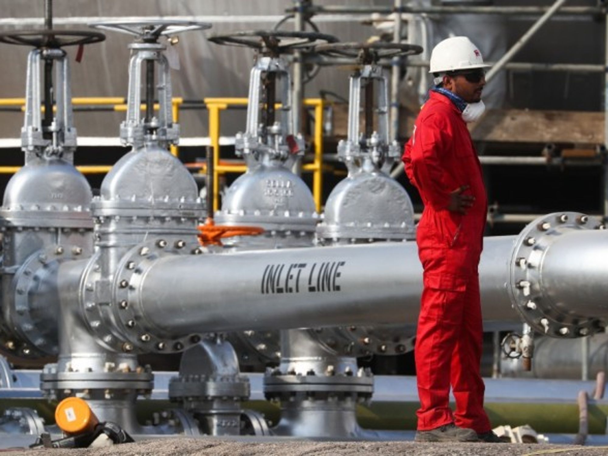 A worker at an oil processing facility of Saudi Aramco, a Saudi Arabian state-owned oil and gas company