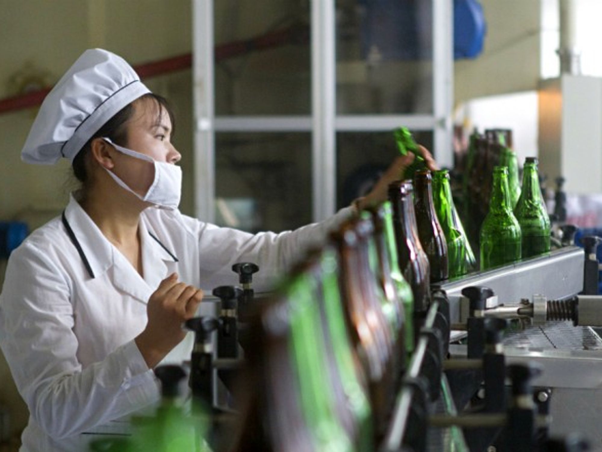 A worker at the Kangso Mineral Water Factory that is shown to foreigners to display its modernized industries
