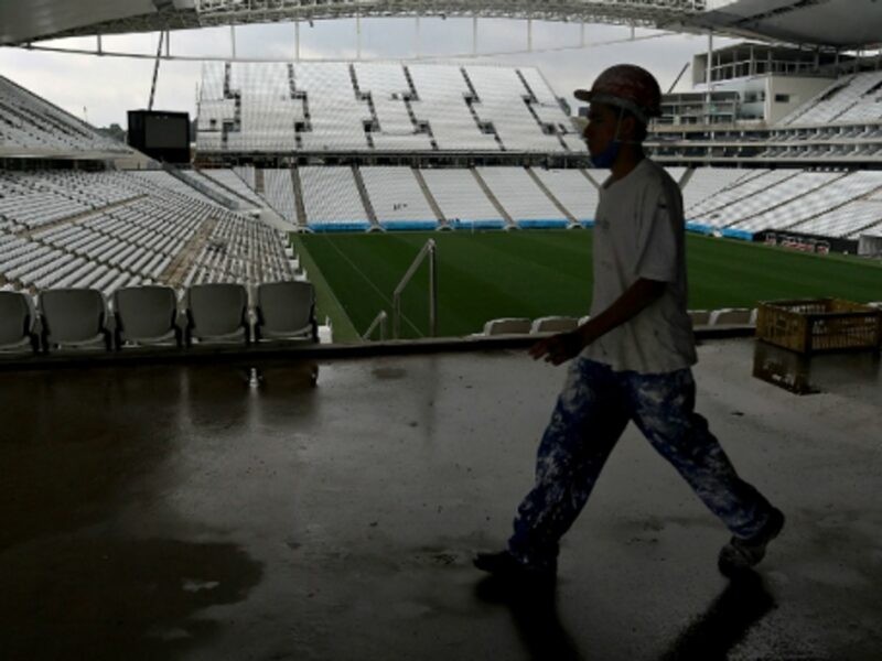 A worker walks inside the Sao Paulo Arena
