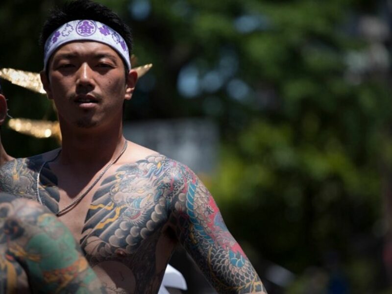 A Yakuza member shows off his tattoos during a 2014 festival in Tokyo in
