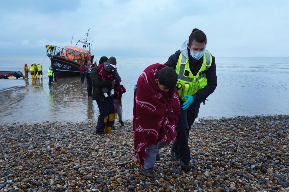 A young boy is helped by a Border Force officer, Kent