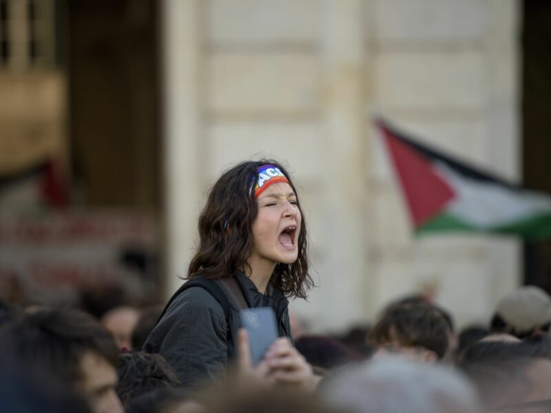 A young girl with a peace hair band shouts phrases of support for Palestine during a demonstration