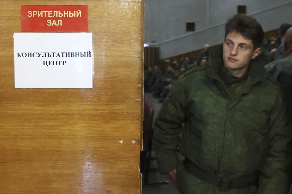A young man at a consultation center in Novosibirsk to register for the mobilization