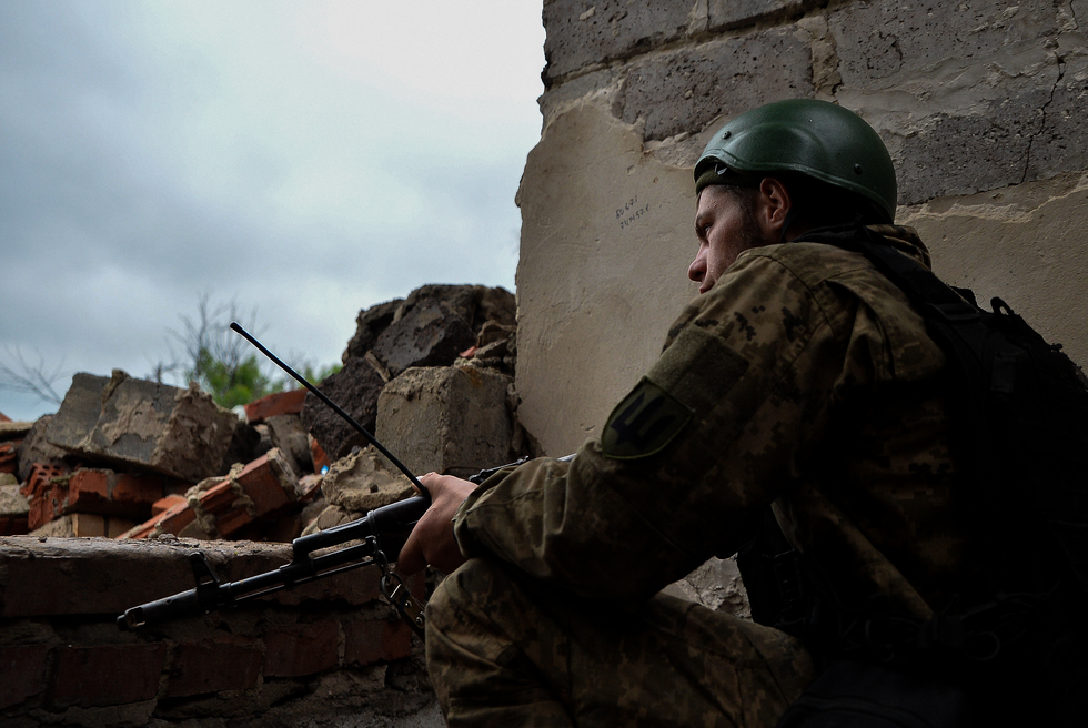 A young soldier stands guard along the zero-line in the Donbas region.