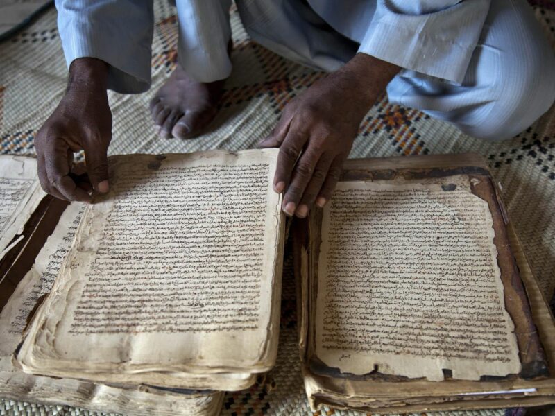 Abdul Wahid shows a manuscript from the 14th century at his house in Timbuktu, North of Mali.