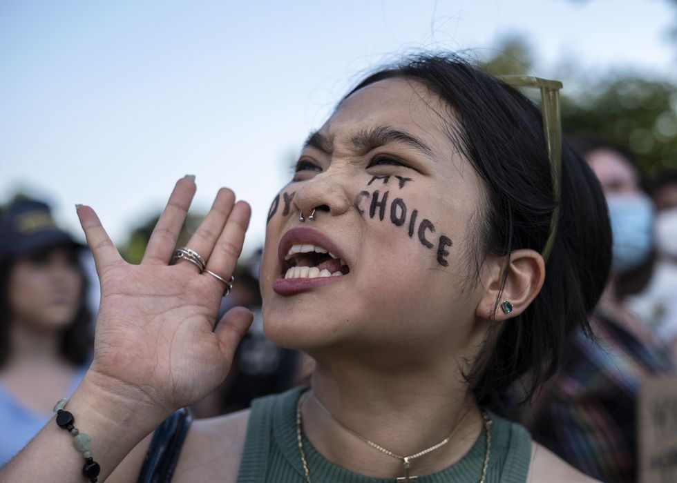 Abortion-rights activist Robin Gwak shouting the slogan "My Body My Choice" in front of the Supreme Court