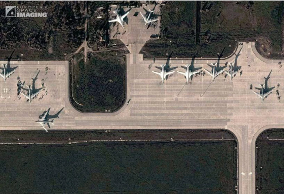 Aerial photo of Engels-2 airbase in Russia showing runway, tarmac with planes parked.