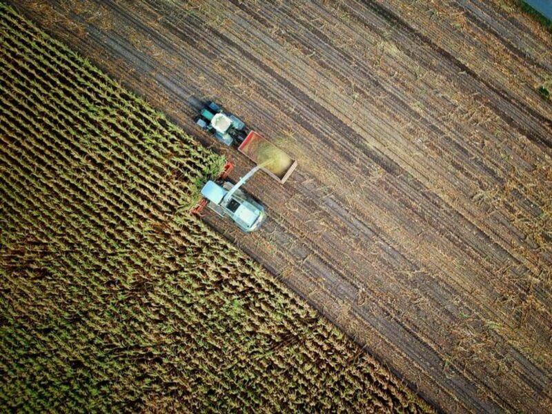 Aerial view of agricultural machines working in a field