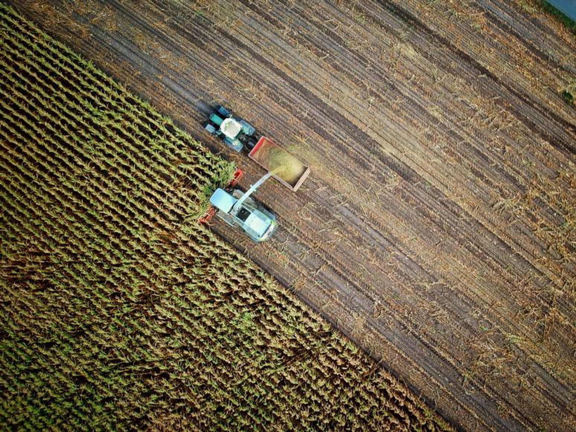 Aerial view of agricultural machines working in a field