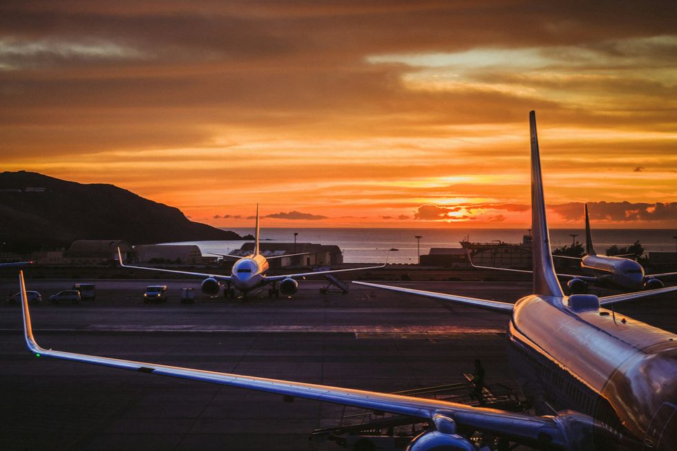 Airplanes on the runway at sunset at Gran Canaria Airport, Spain.