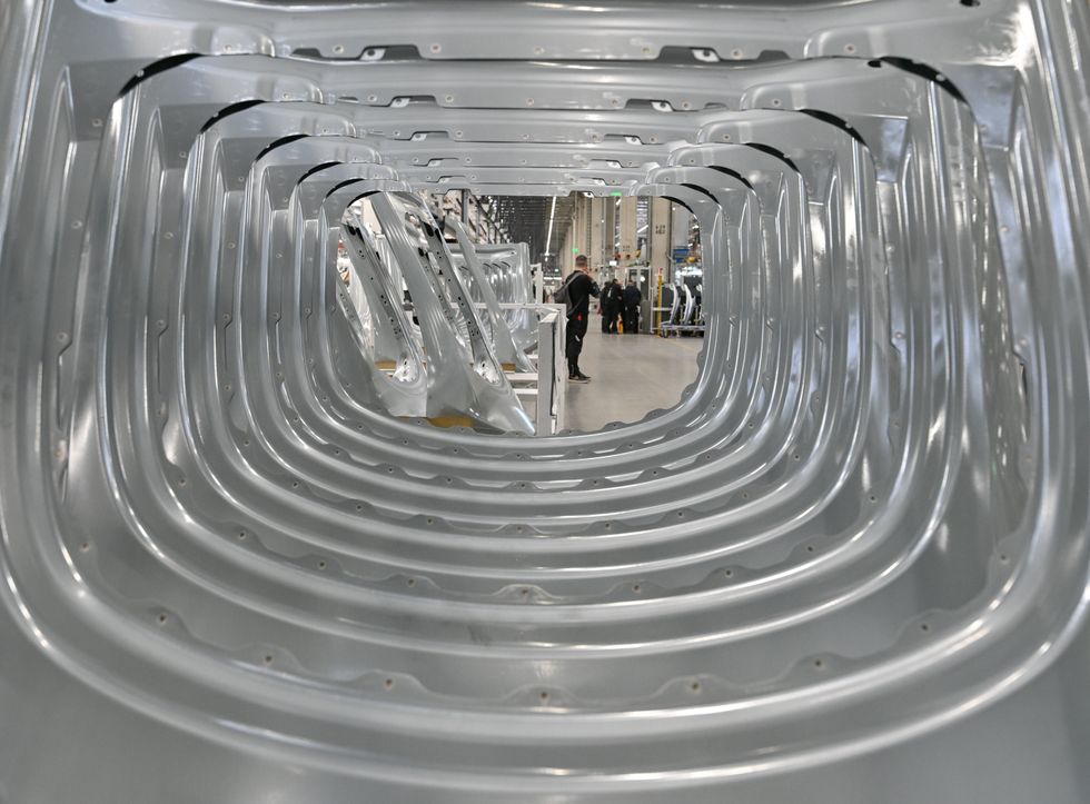 Aluminum body parts for the Model Y electric vehicle stand in the Tesla Gigafactory Berlin Brandenburg plant.