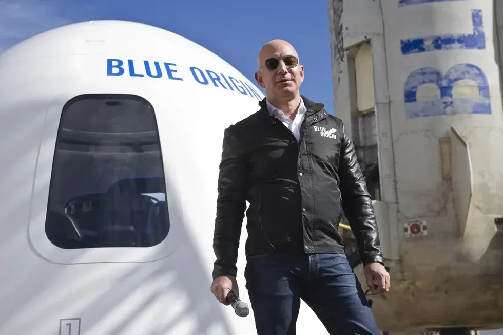 Amazon's Jeff Bezos in front of his Blue Origin rocket