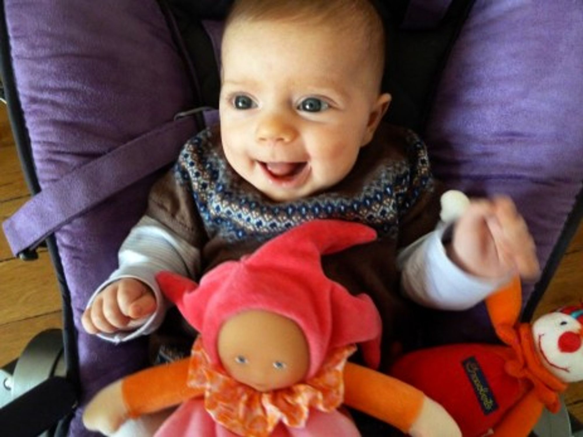An 11-week-old baby enjoying a funny moment