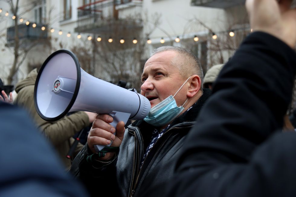An activist uses a loudspeaker during the Rally of Justice initiated by the families whose relatives died as a result of military hazing held outside the Office of the President.